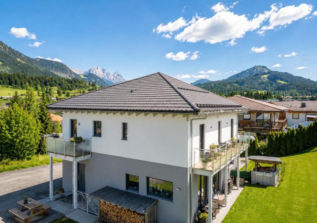 an aerial view of a house with mountains in the background at Mountain Chalet Top 3- mit Garten und Grill in Fieberbrunn