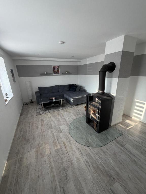 a living room with a couch and a fireplace at Dorfquartier am Gut in Remstädt