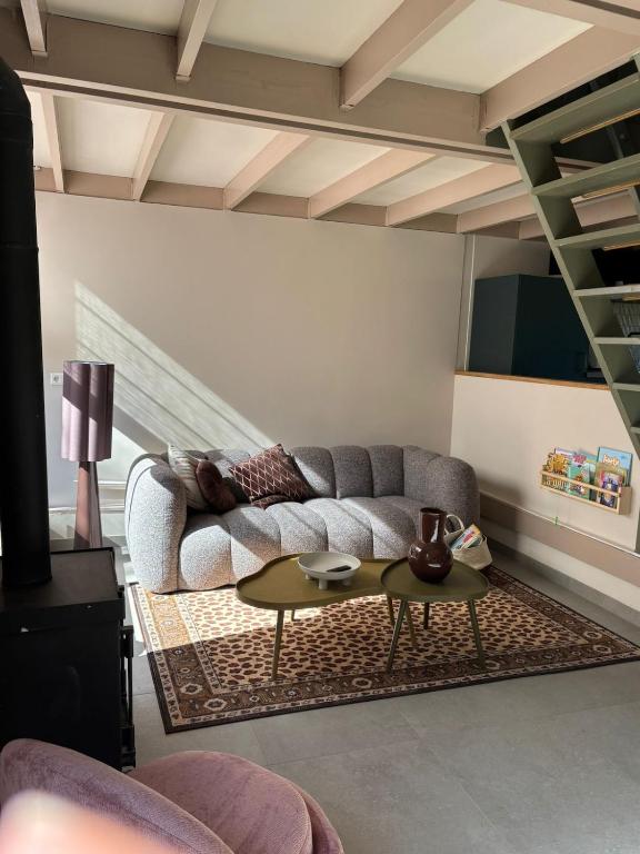 a living room with a couch and a table at De Strandjutter in Warmenhuizen