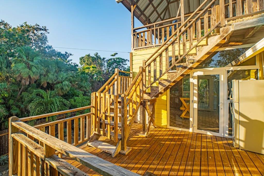 a wooden deck with a staircase on a house at 2 Coco Locos at Sunset in Seine Bight Village