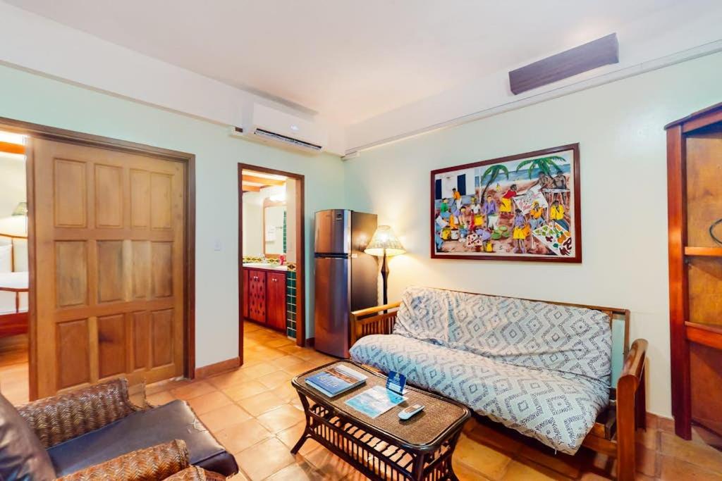 a living room with a couch and a table at Condo #25 @ Beachside Villas in Placencia