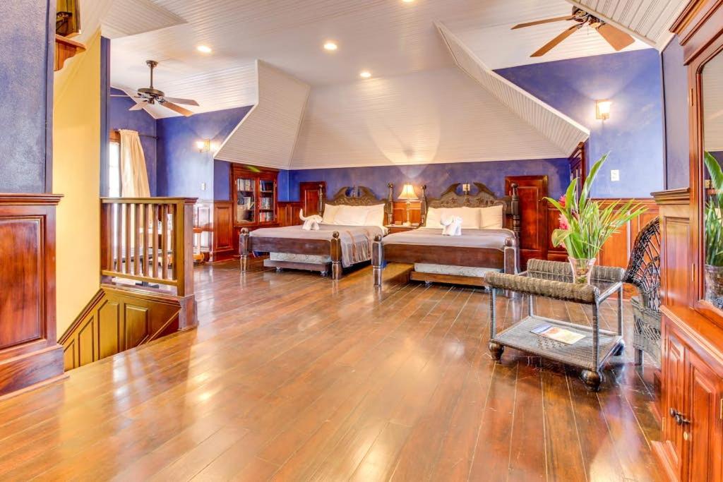 a bedroom with two beds in a room at Crow's Nest Suite at Mahogany Hall -Gold Standard Certified in San Ignacio