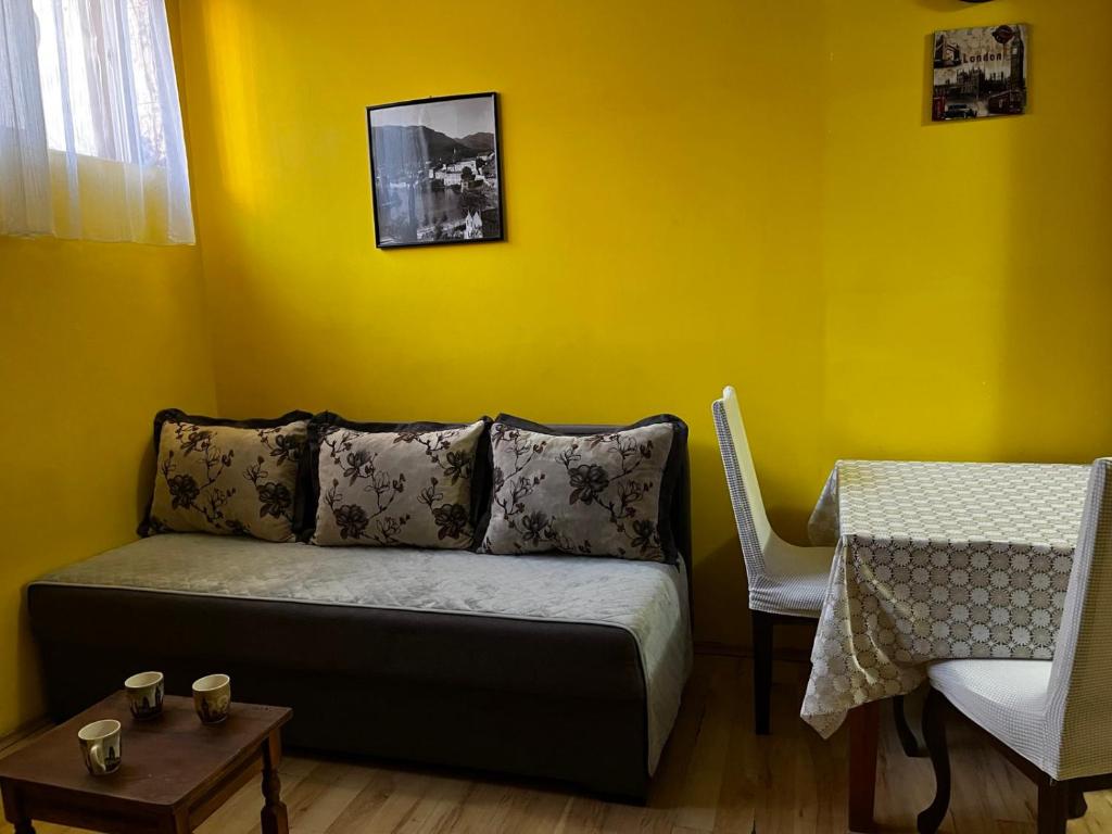 a living room with a couch and a table at Cozy studio in Budva in Budva