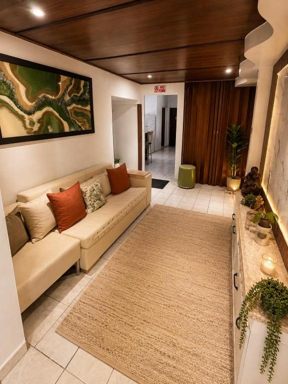 a living room with a couch and a rug at Natural Village ROOM #1,2,3 & 5 in San Juan