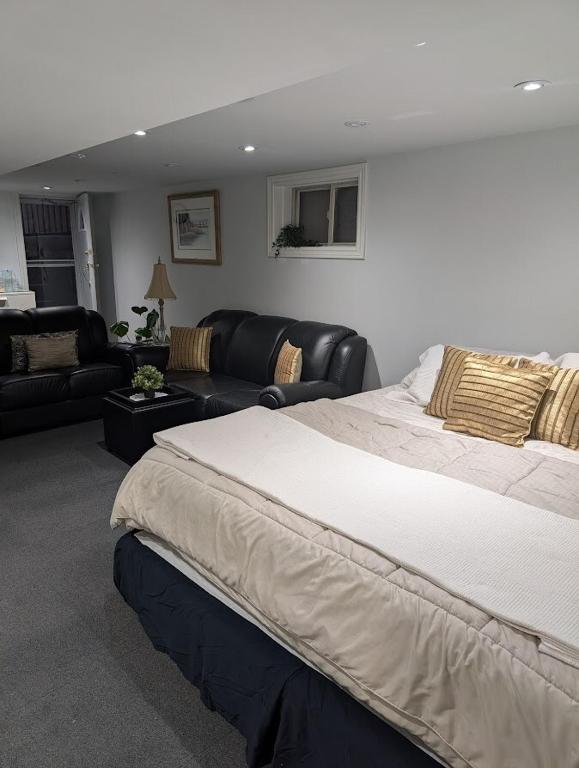a bedroom with a large bed and a living room at King Size In-Suite Basement in Toronto