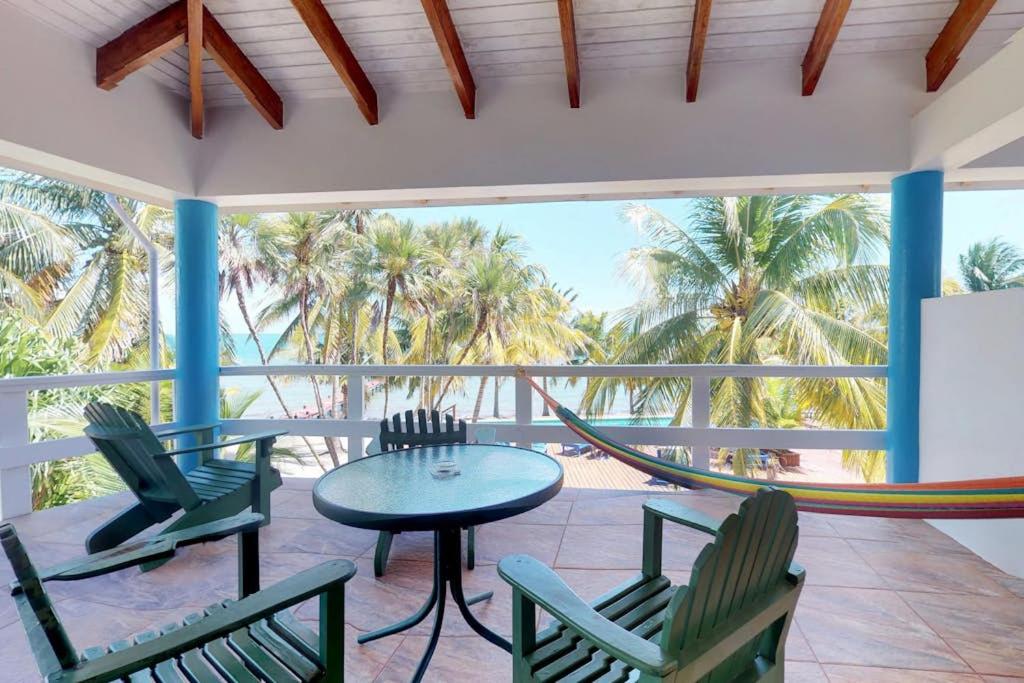 a hammock on a porch with chairs and a table at Condo #22 @ Beachside Villas in Seine Bight Village