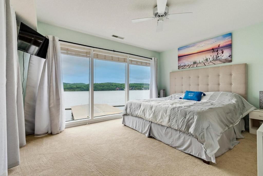 a bedroom with a bed and a large window at Baypoint Paradise in Osage Beach