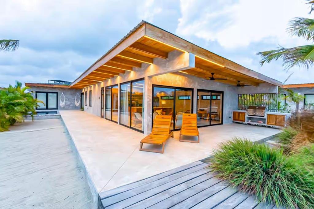 a house with a deck with chairs on it at Seabird Villa 11 in Placencia