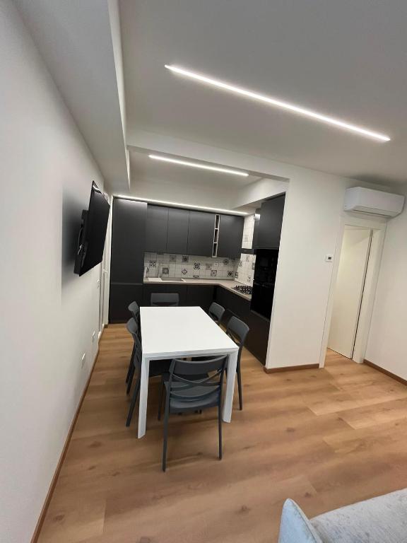 a dining room with a white table and chairs at mama house in Marotta