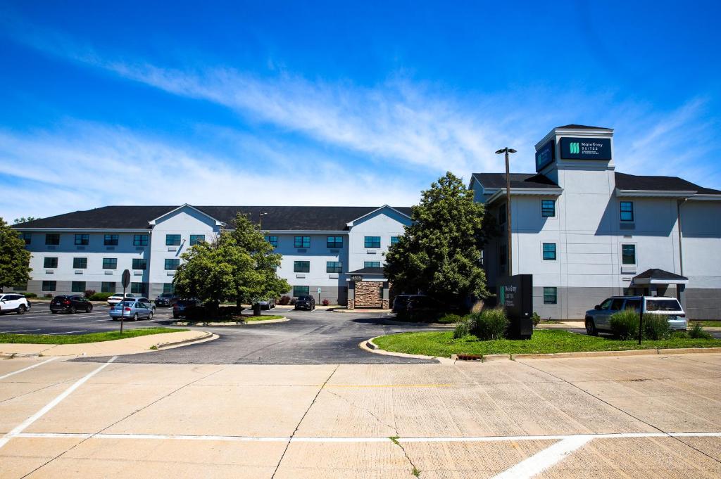 a large building with a parking lot in front of it at MainStay Suites Chicago Hillside in Hillside