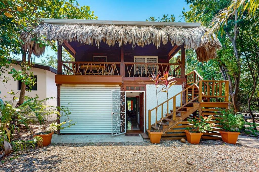 a house with a deck and a garage at Bungalow Bobo in Placencia