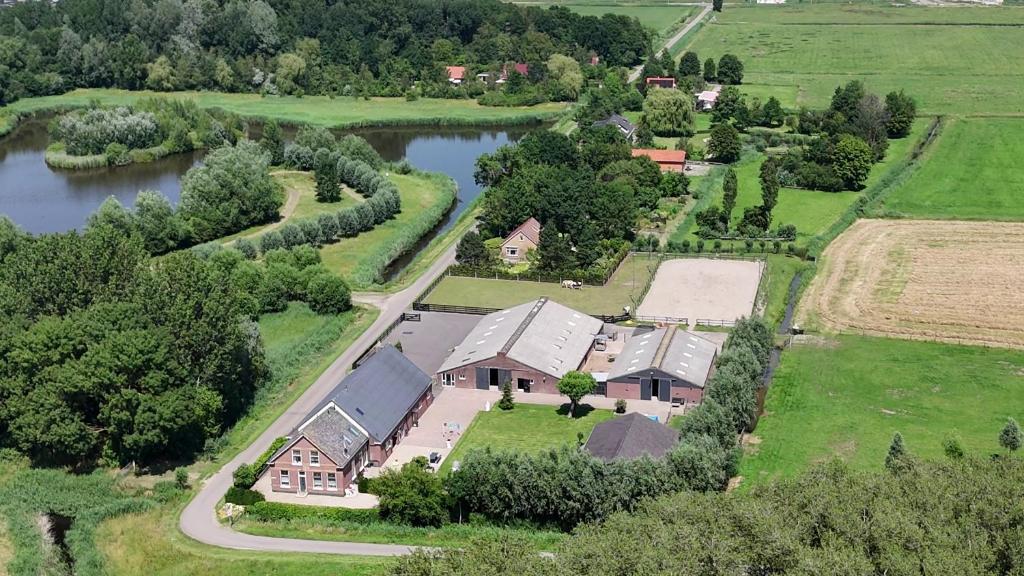 an aerial view of a house and a river at Hoeve Tramzicht in Hellevoetsluis