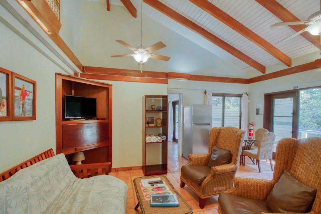 a living room with a couch and a ceiling fan at Condo #27 @ Beachside Villas in Seine Bight Village