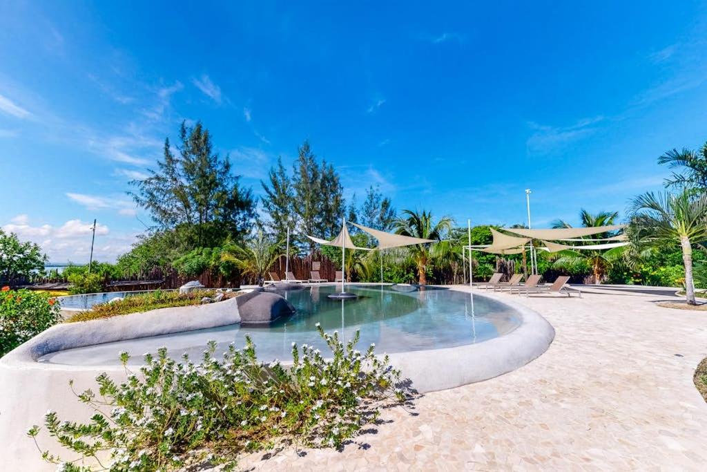 a swimming pool with umbrellas in a resort at Dolphin @ Swan Villas in Maya Beach