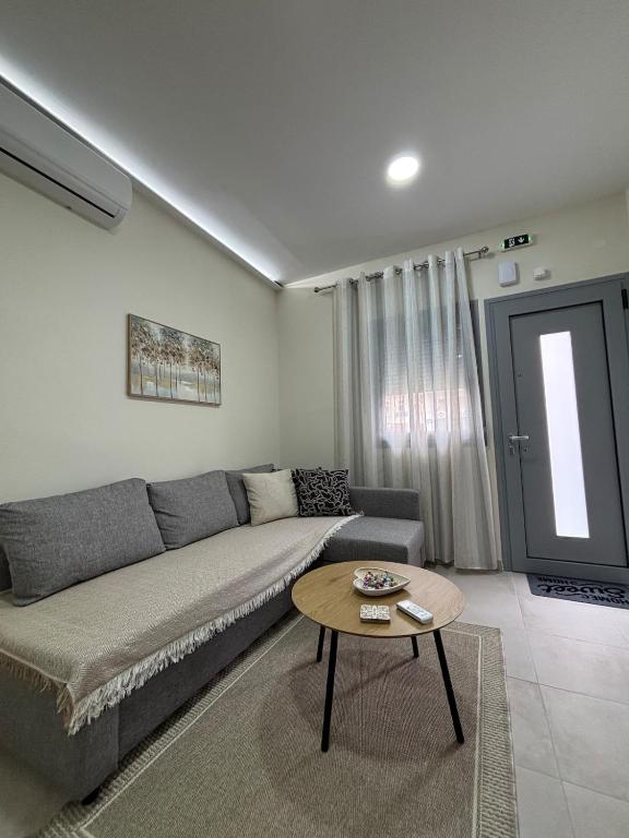 a living room with a couch and a table at Paloma Apartment in Drama