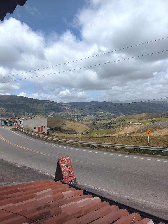 a sign on the side of a road at Hospedaje Los Tumbilos in Silos