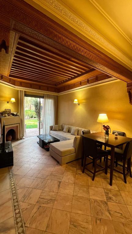 a living room with a couch and a table at Les Jardins de la Palmeraie 3 in Marrakesh