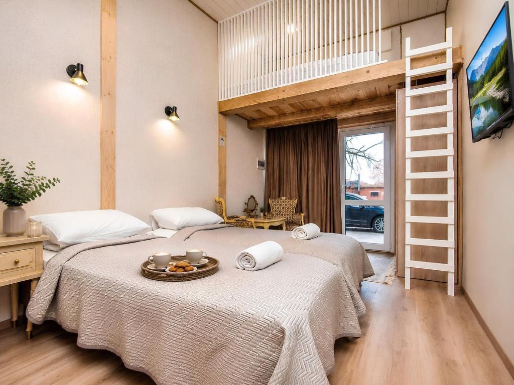 two beds in a room with a bunk bed at KUBU Loft in Klaipėda