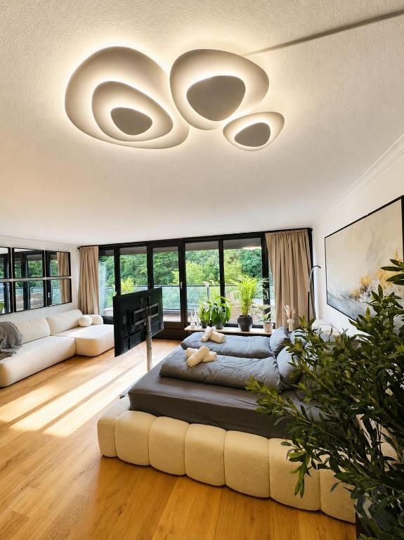 a living room with a large bed in the middle at Velmora Boutique Suites - Wellness - Pool, Sauna, E-Bikes direkt am Strand in Timmendorfer Strand