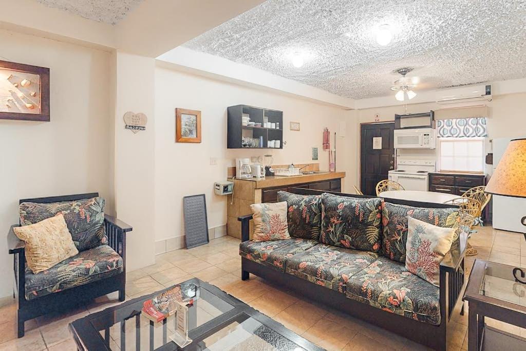 a living room with a couch and a kitchen at Family Getaway Suite at Hummingbird Home Suites Gold Standard Certified in San Pedro