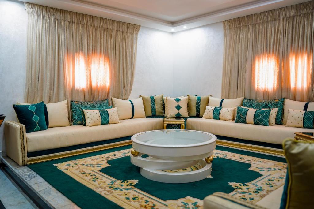 a living room with two couches and a table at dakhla home in Aït Krad