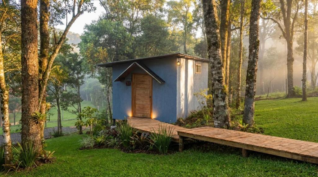 a tiny house in a forest with a wooden platform at Espaço Luna in Gramado