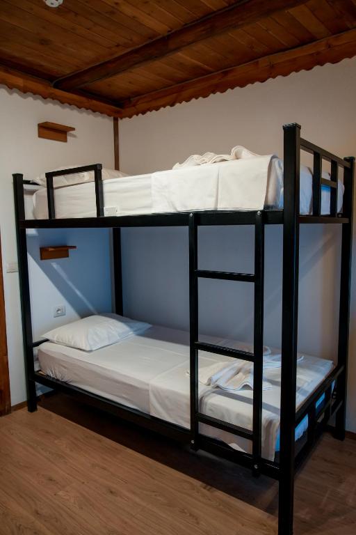 a couple of bunk beds in a room at Beds Hostel in Gjirokastër