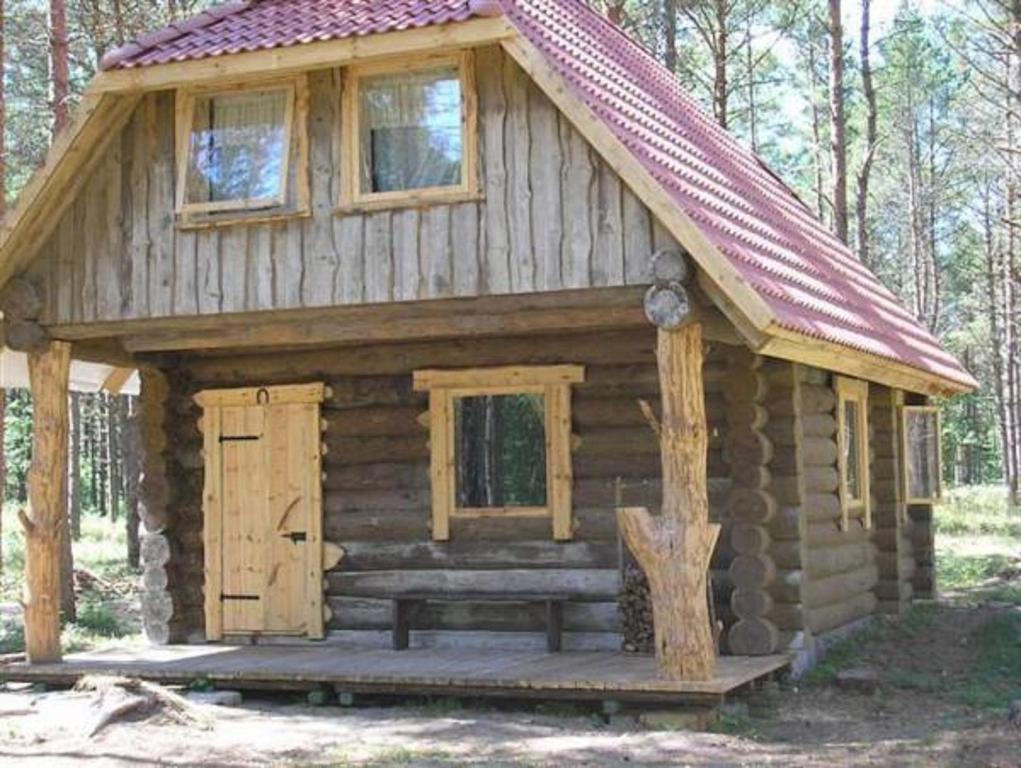 a log cabin with a bench in front of it at Järve Cottages in Tehumardi