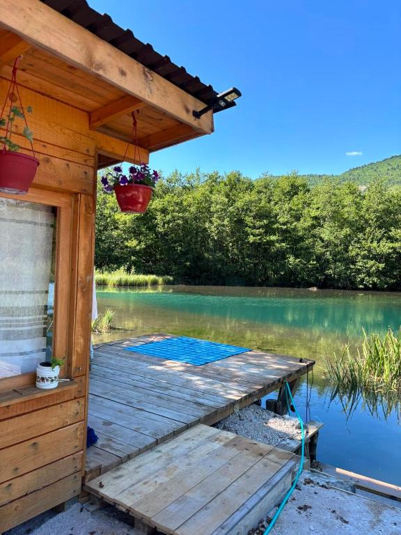 a wooden deck next to a body of water at Pliva Escape in Jezero