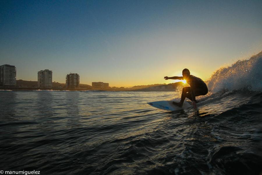 a man riding a wave on a surfboard in the ocean at El Pez Escorpion in Salinas