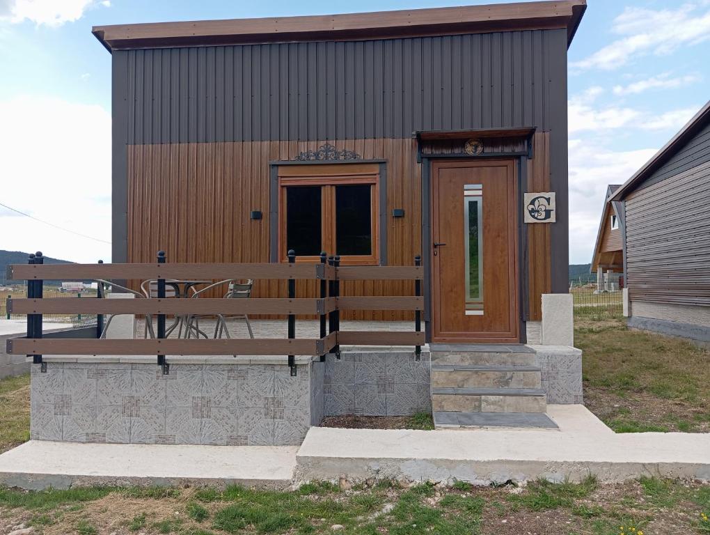 a small building with a bench in front of it at Četiri sestre in Žabljak