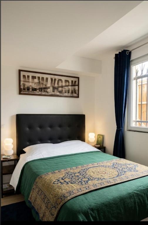 a bedroom with a large bed and a window at "Aux Portes de CDG" in Thieux