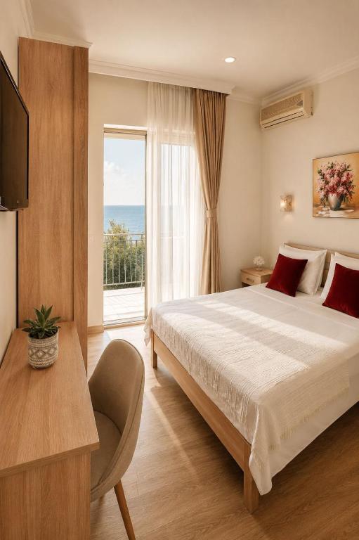 a bedroom with a large bed and a window at Apartments Hollaj in Ulcinj