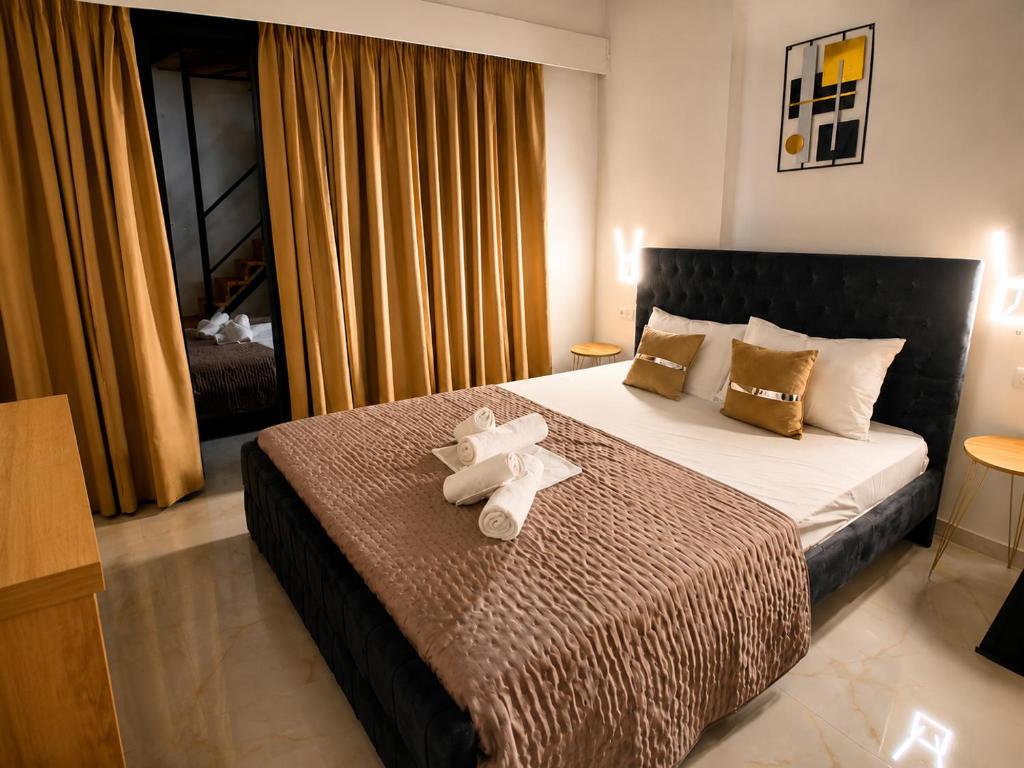 a hotel room with a bed with towels on it at GLP Sivota in Syvota