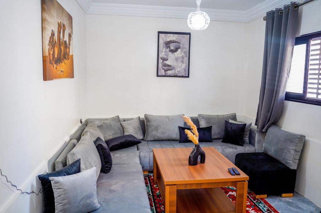 a living room with a couch and a table at oasis house in Takchrirt