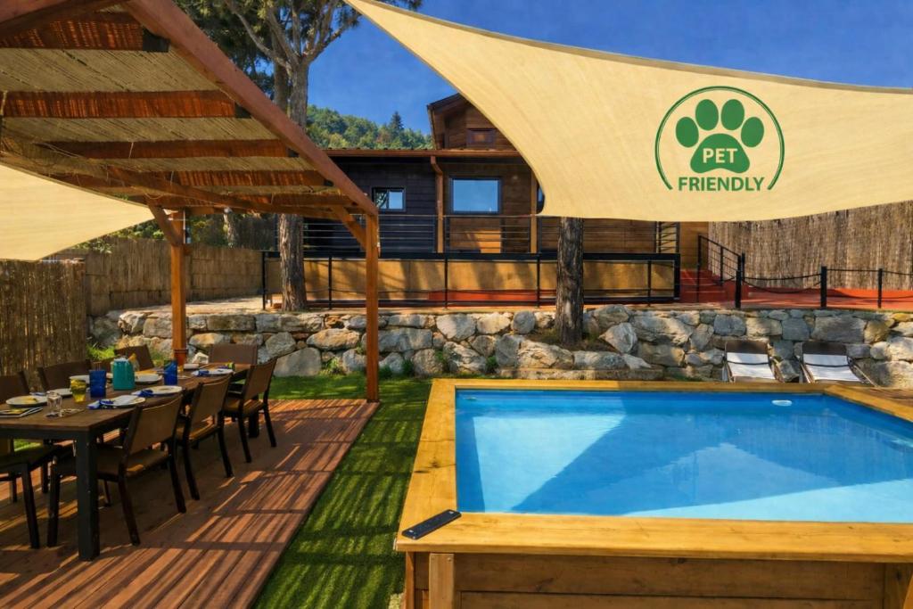 a pool at a resort with a table and a patio at NEW Family Villa ideal para familias in Pineda de Mar