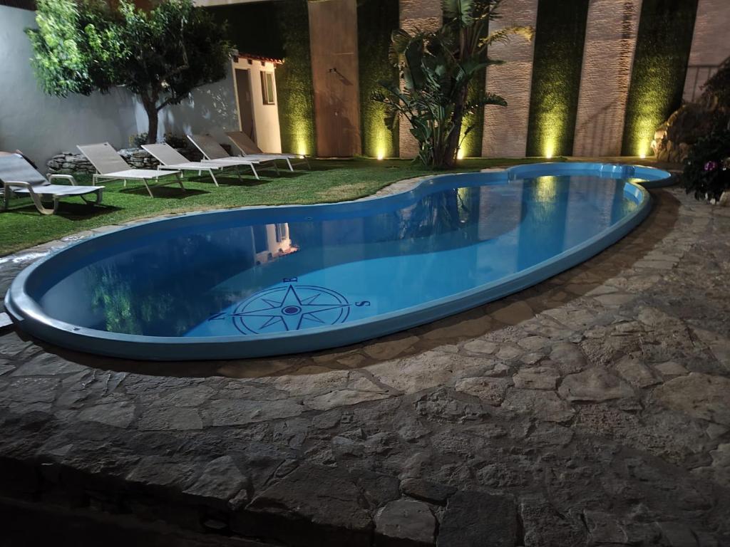 a swimming pool in the middle of a yard at North Wind House in Peniche