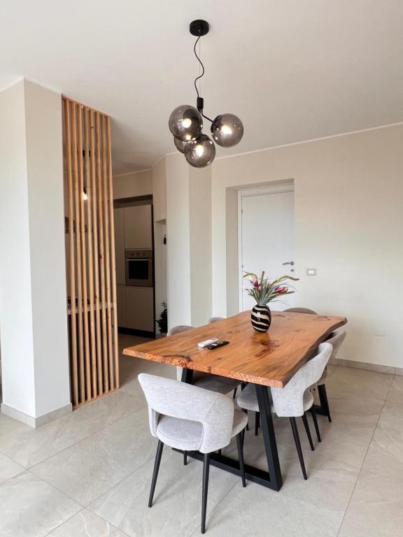 a dining room with a wooden table and chairs at Zen Apartment in Santa Maria del Cedro
