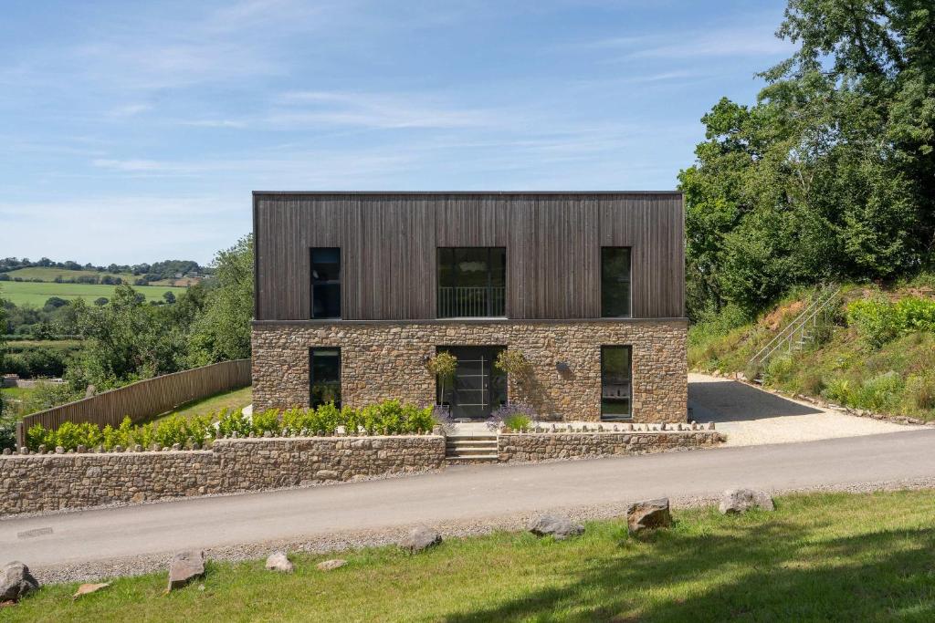 a house on a hill with a stone facade at Brockview House - Eco 4 bed in Holcombe