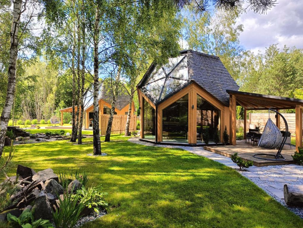 a home with a gazebo in a yard at Domy Kopułowe 5th Wymiar in Skrybicze