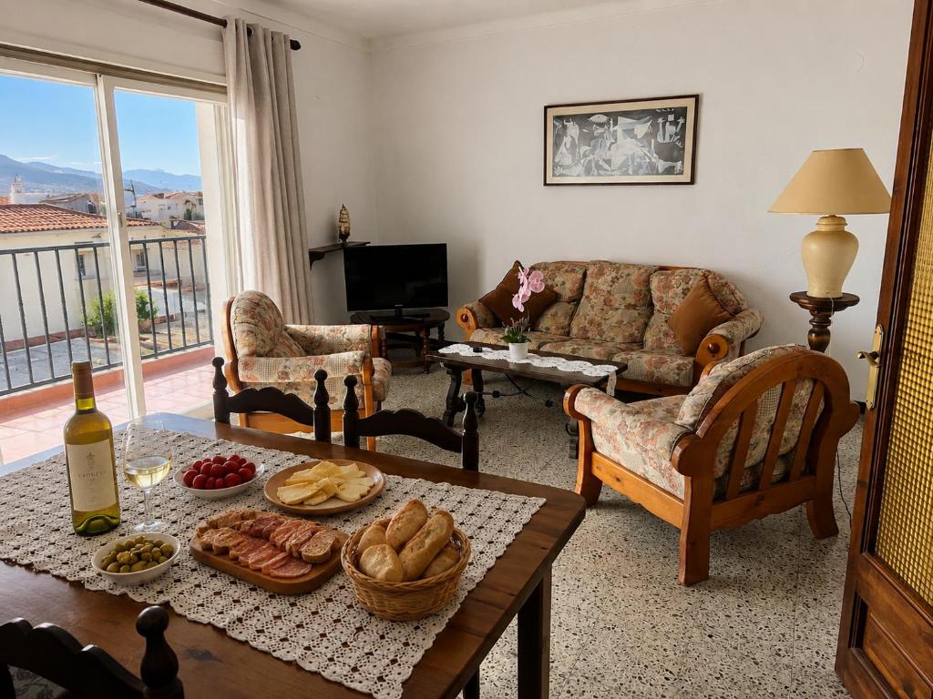 a living room with a table with food on it at AMALIA 1 in L'Escala