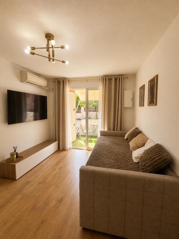 a bedroom with a large bed and a flat screen tv at Studio hesperides in Balaruc-les-Bains