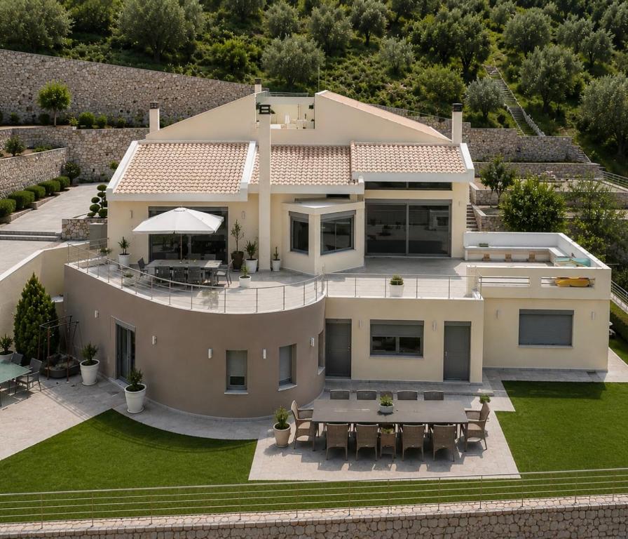 an aerial view of a house with a patio at Mytilene Luxury Villa Garden Level in Mytilene