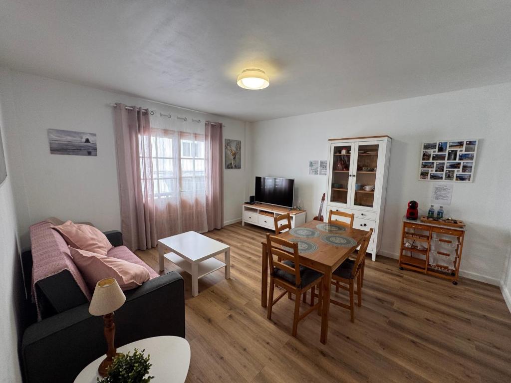 a living room with a couch and a table at Casa Rosales in La Orotava