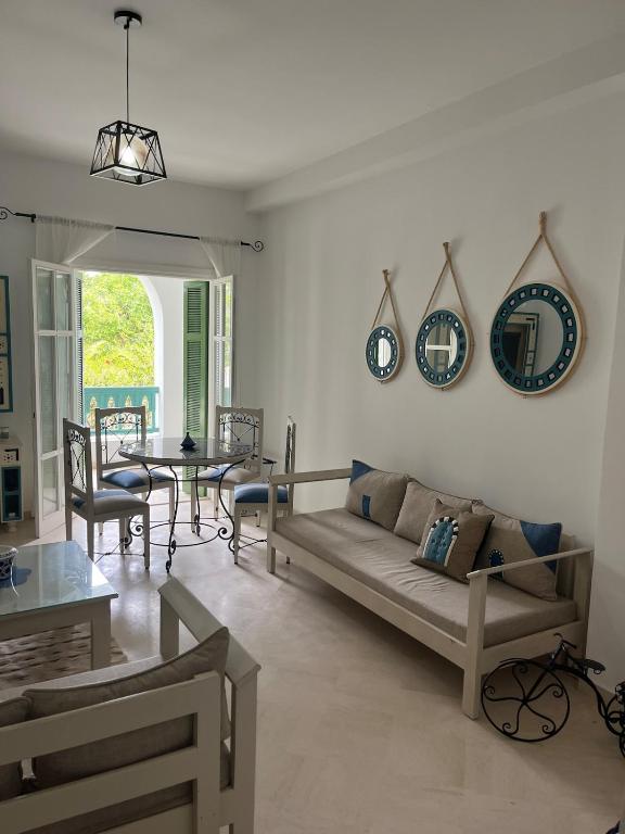a living room with a couch and a table at Arabesque-style apartment in Yasmine