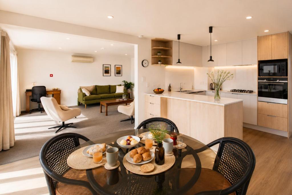 a kitchen and living room with a table and chairs at Tresco Apartments - Quiet Luxury in the Heart of Blenheim in Blenheim