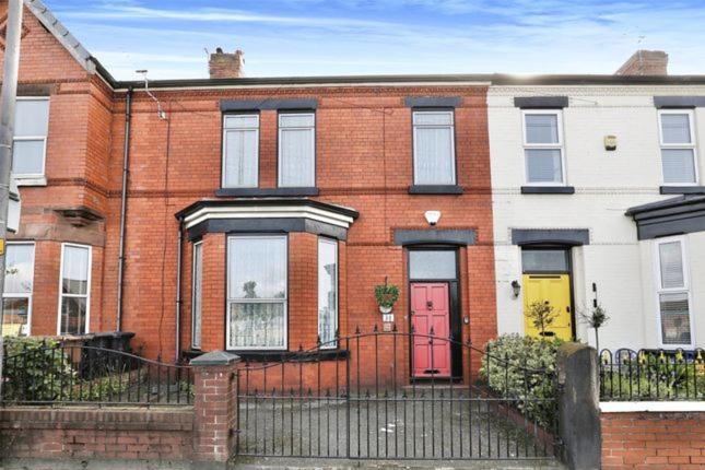 a brick house with a red door on a street at Crosby & Waterloo Beachside Stay in Waterloo