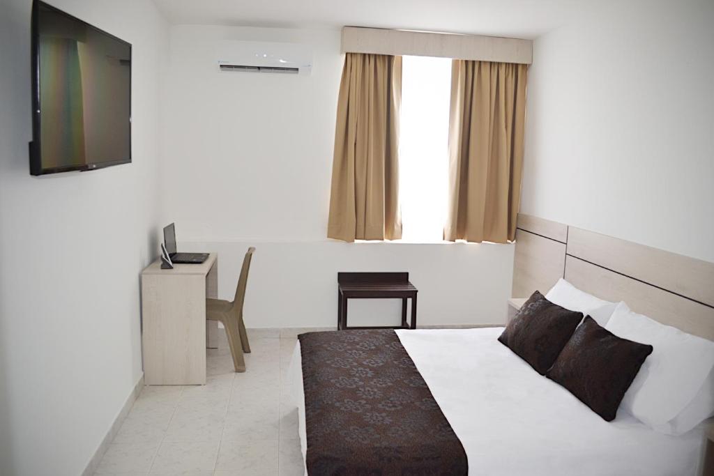 A bed or beds in a room at Hotel Kurakatá