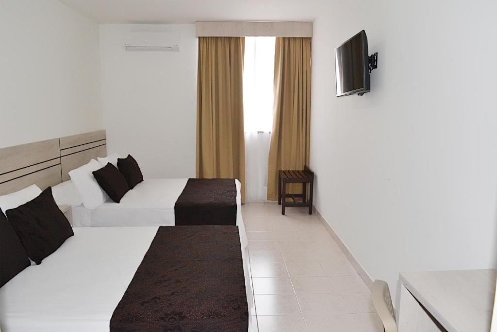 A bed or beds in a room at Hotel Kurakatá