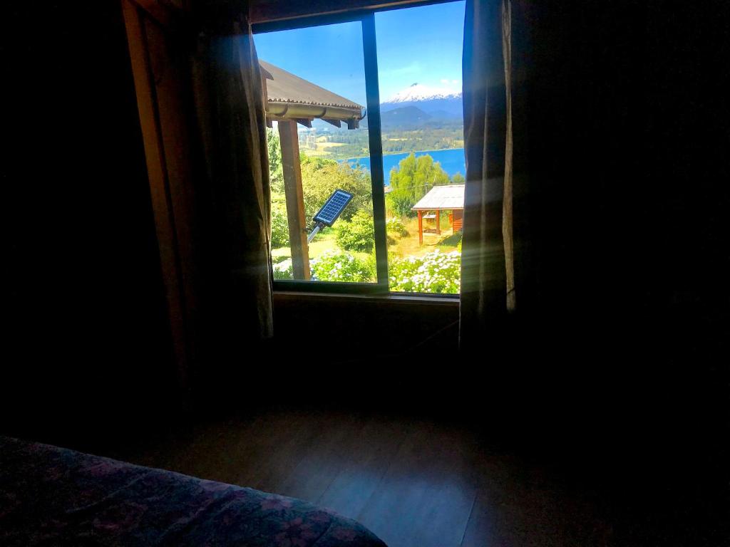 a window view of a mountain view from a house at Cabañas Rayen Lemu in Panguipulli